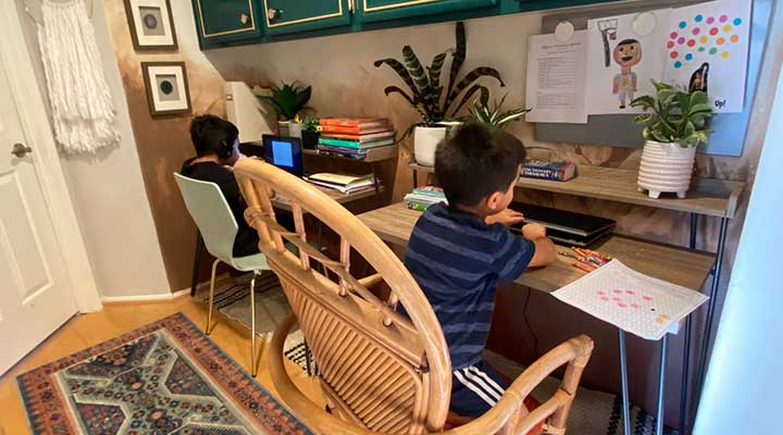 two young boys at their desks which are in a hallway converted into a stylish study space